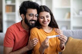 Happy couple celebrating positive pregnancy news at Dr Samina Ahmed’s clinic
