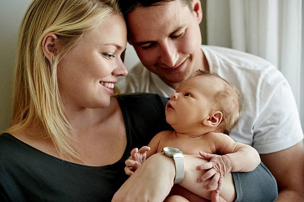 Couple holding their newborn baby after successful delivery with Dr Samina Ahmed