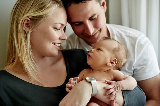 Couple holding their newborn baby after successful delivery with Dr Samina Ahmed